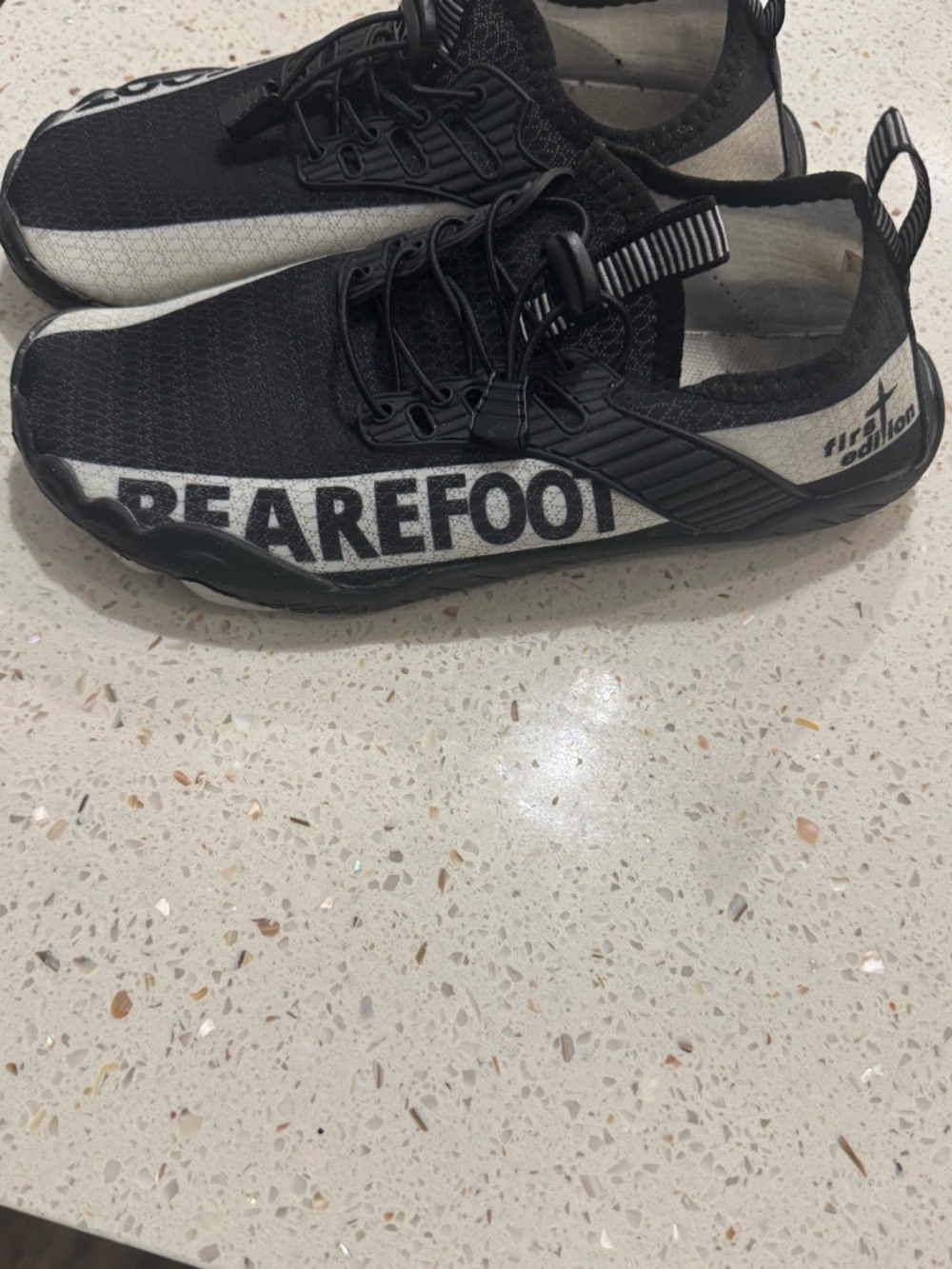 Black Slip-On Athletic Sneakers with White Side Stripe and Bold Side Text